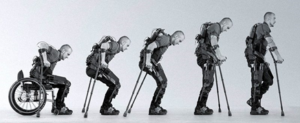 Series of pictures from man sitting in wheelchair to gradually standing in exoskeleton brace.